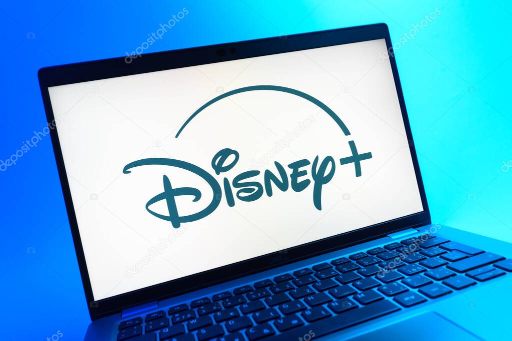 Prague, Czechia - 05 08 2025: A close-up view of a laptop lying on a colorful background, showing Disney + logo.