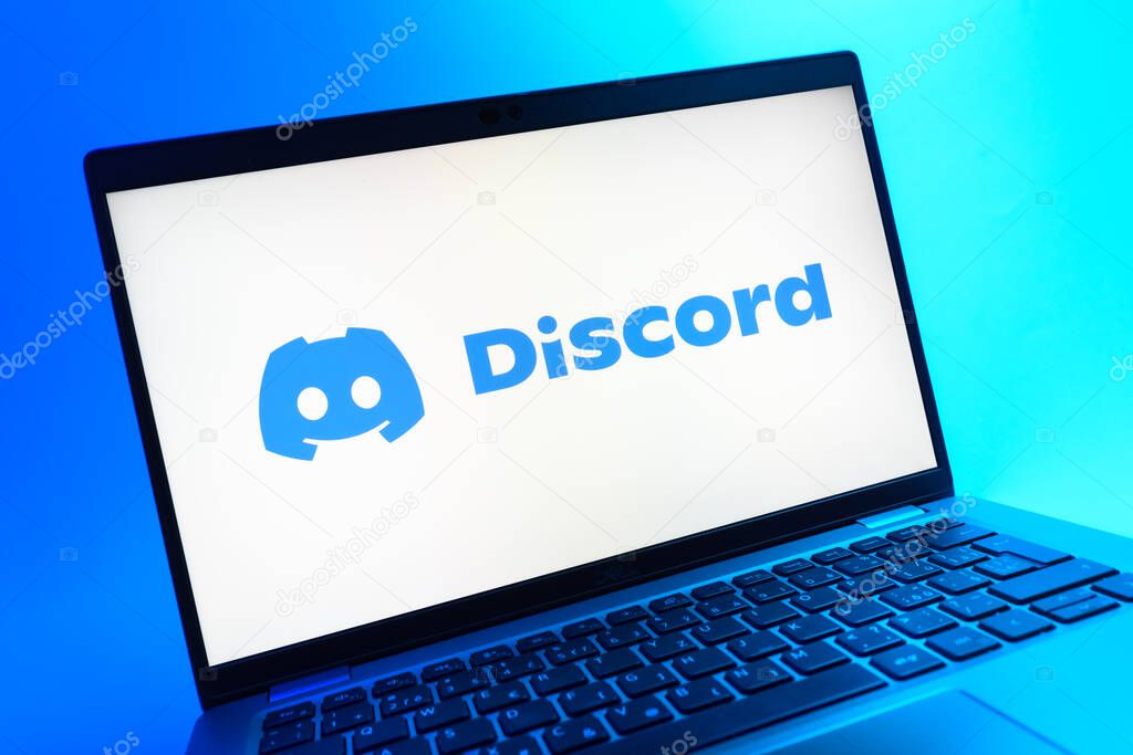 Prague, Czechia - 05 08 2025: A close-up view of a laptop lying on a colorful background, showing Discord logo.