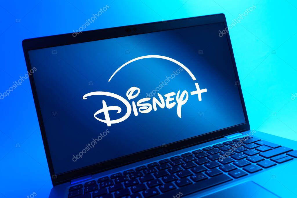 Prague, Czechia - 05 08 2025: A close-up view of a laptop lying on a colorful background, showing Disney + logo.