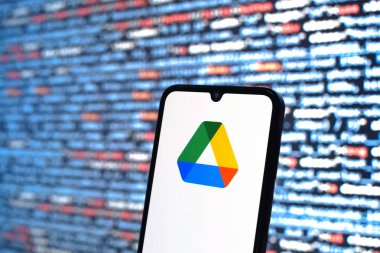 Prag, Çek Cumhuriyeti - 05: 18 2025: Kaynak kodlu arkaplan önündeki akıllı telefon Google Drive logosunu görüntüler.
