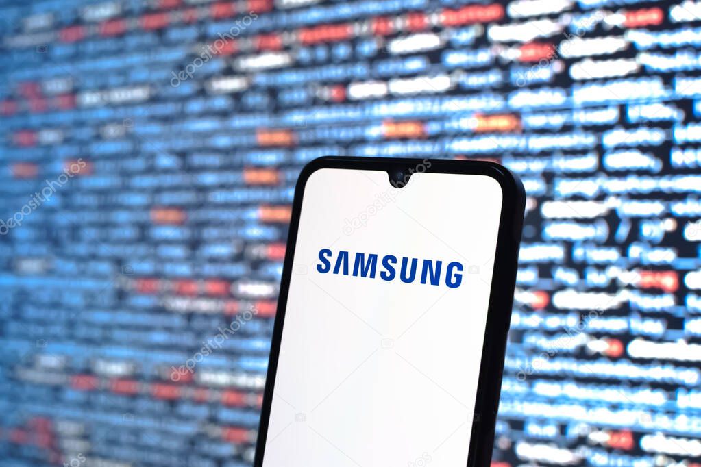 Prague, Czechia - 05 18 2025: A smartphone in front of source code background displays Samsung logo.