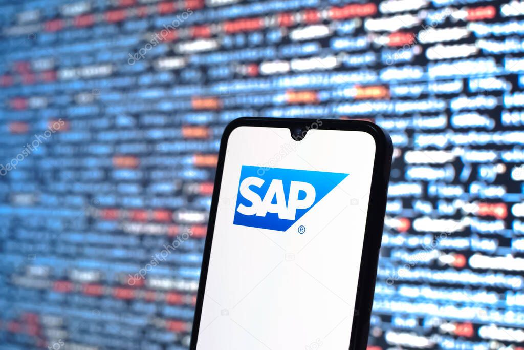 Prague, Czechia - 05 18 2025: A smartphone in front of source code background displays SAP logo.