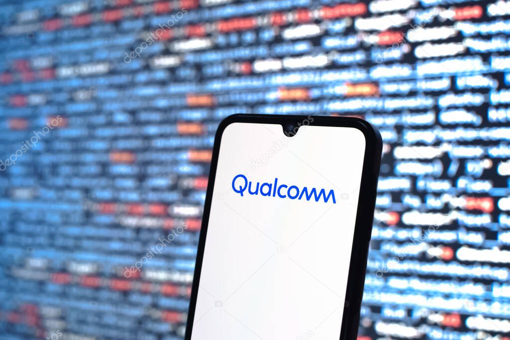 Prague, Czechia - 05 18 2025: A smartphone in front of source code background displays Qualcomm logo.