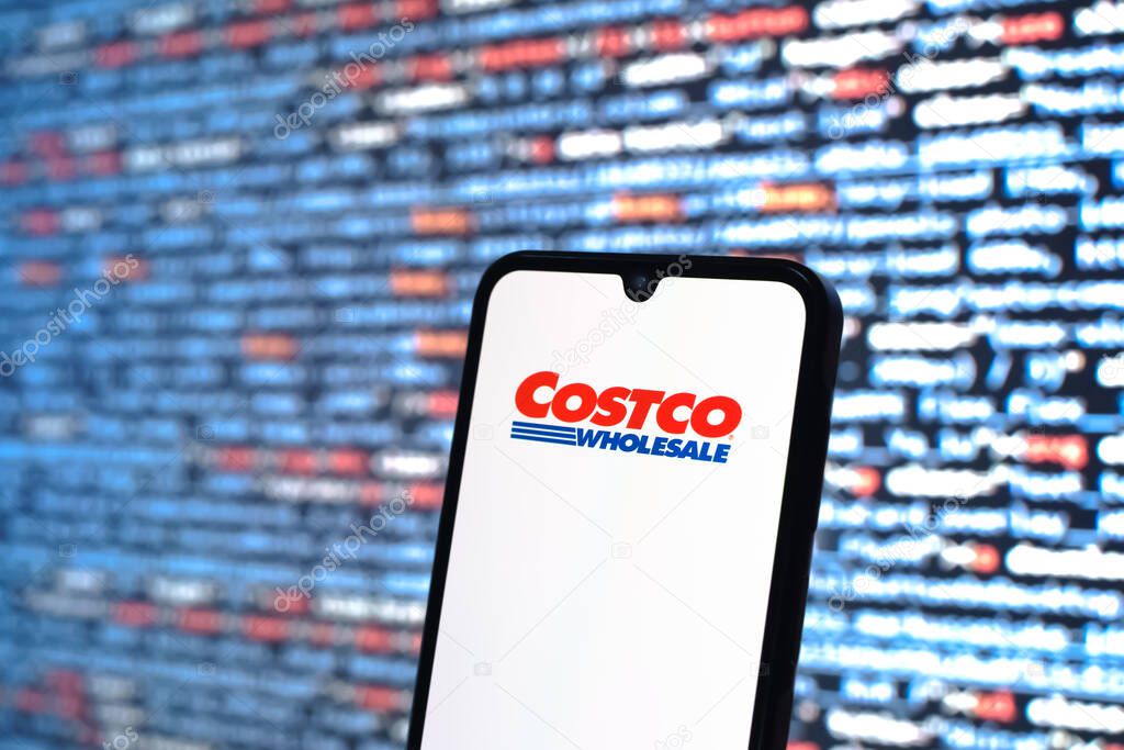 Prague, Czechia - 05 18 2025: A smartphone in front of source code background displays Costco logo.