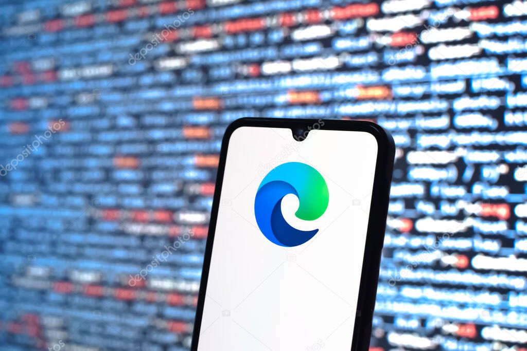 Prague, Czechia - 05 18 2025: A smartphone in front of source code background displays Edge logo.