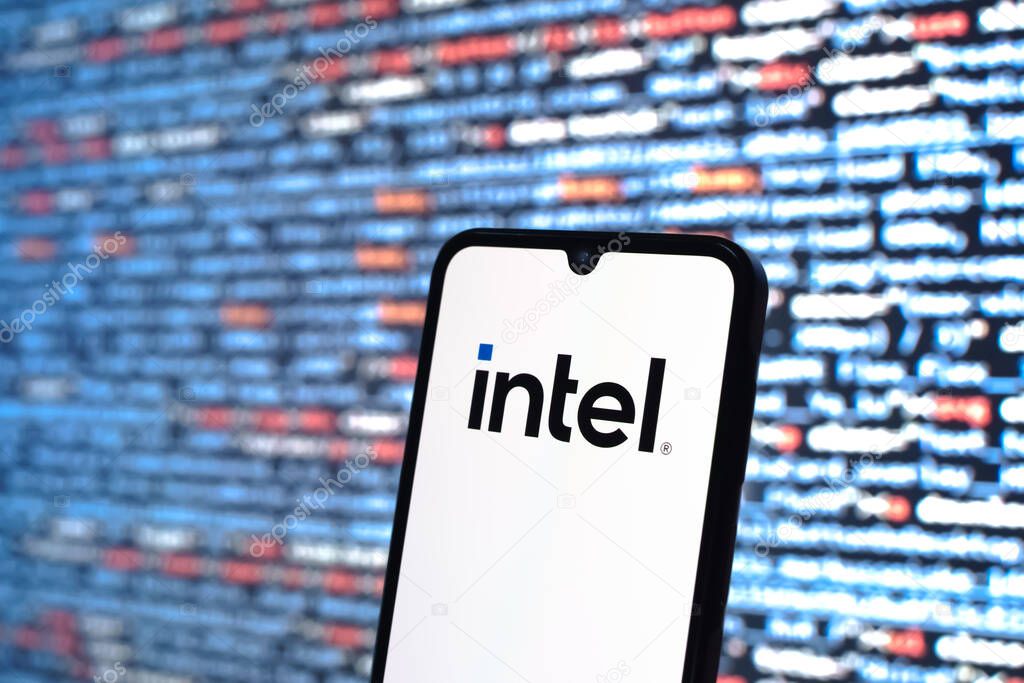 Prague, Czechia - 05 18 2025: A smartphone in front of source code background displays Intel logo.