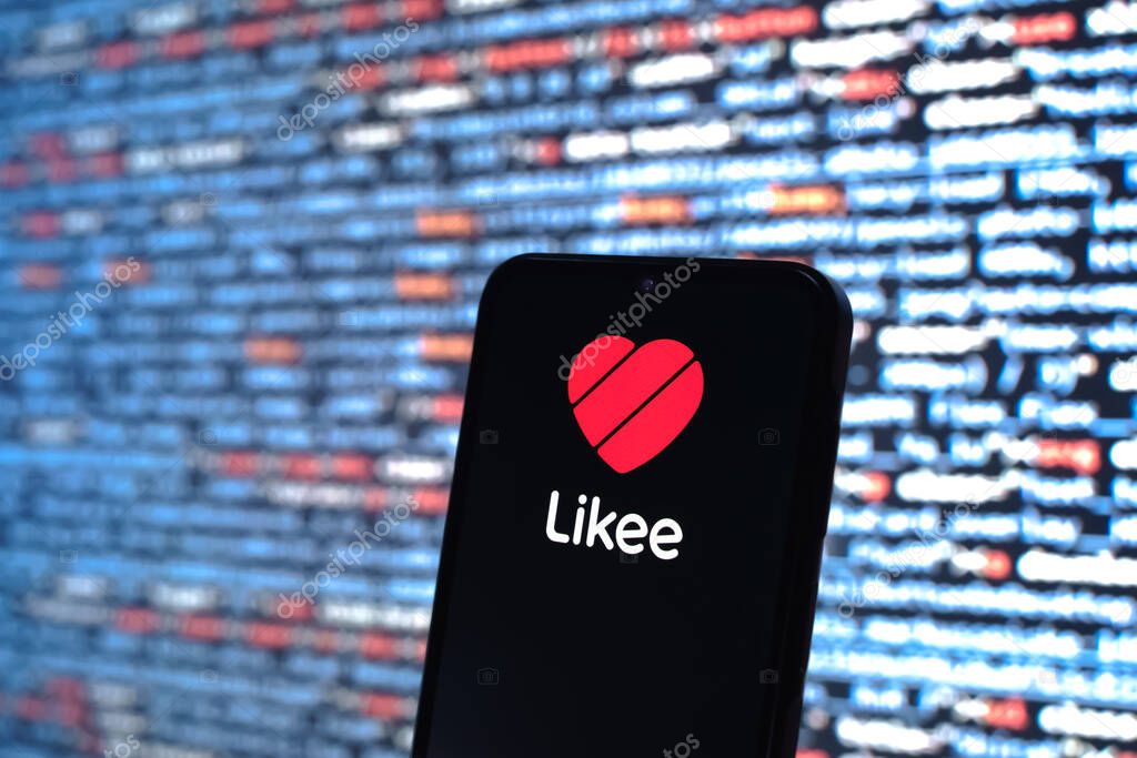 Prague, Czechia - 05 18 2025: A smartphone in front of source code background displays Likee logo.