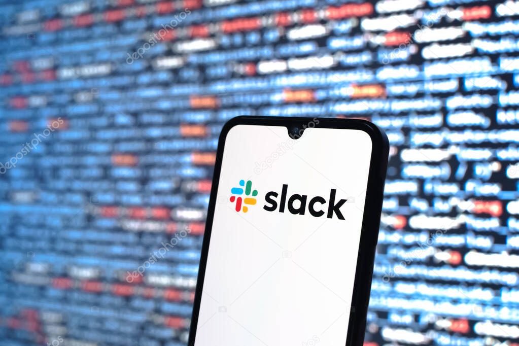 Prague, Czechia - 05 18 2025: A smartphone in front of source code background displays Slack logo.