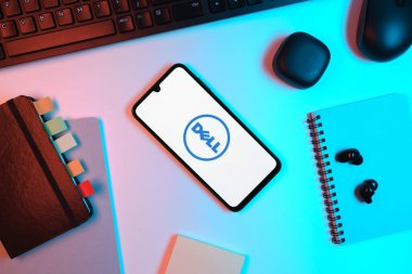 Prag, Çek Cumhuriyeti - 05: 18 2025: Dell logosunu gösteren bir telefonla ofis masasına yerleştirilmiş nesneler.