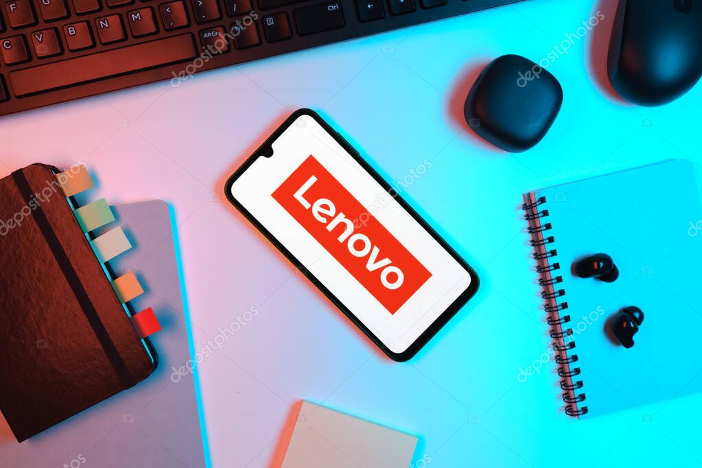Prague, Czechia - 05 18 2025: Objects arranged on an office desk with a phone showing Lenovo logo.