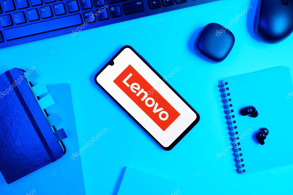 Prague, Czechia - 05 18 2025: Objects arranged on an office desk with a phone showing Lenovo logo.