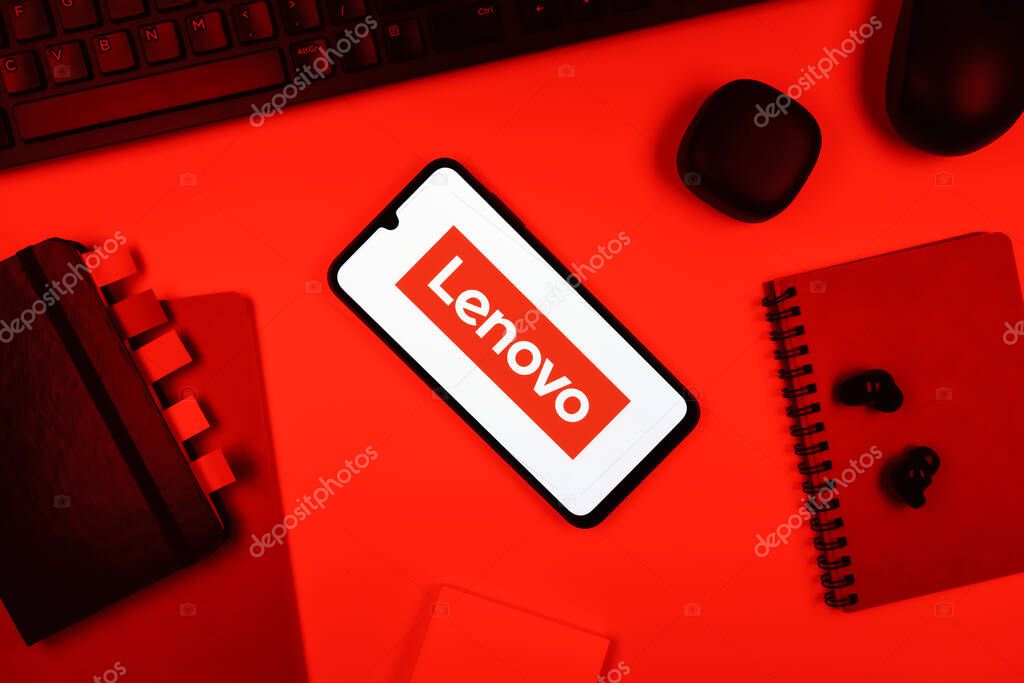 Prague, Czechia - 05 18 2025: Objects arranged on an office desk with a phone showing Lenovo logo.