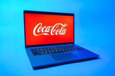 Prag, Çek Cumhuriyeti - 08 01 2025: Tek tip arka planda bir dizüstü bilgisayar Coca-Cola logosunu gösterir. Coca-Cola meşrubatlarıyla tanınan bir içecek şirketidir..
