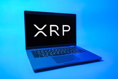 Prag, Çek Cumhuriyeti - 08 01 2025: Tek tip arkaplanda bir dizüstü bilgisayar Ripple logosunu gösterir. Dalgalanma dijital kripto para birimi ve ödeme protokolüdür..