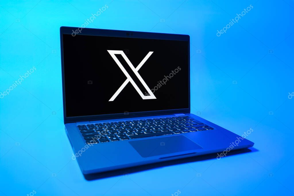 Prague, Czechia - 08 01 2025: A laptop on a uniform background displays the X logo. X is a platform for sharing short posts and updates.