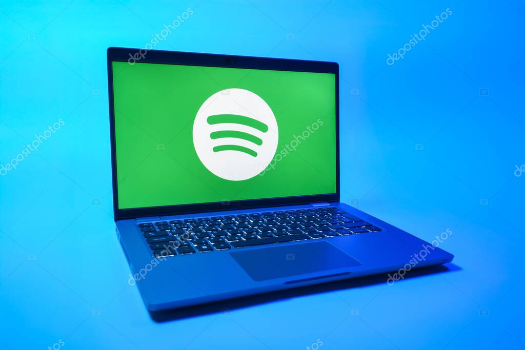 Prague, Czechia - 08 01 2025: A laptop on a uniform background displays the Spotify logo. Spotify is a platform for streaming and discovering music.