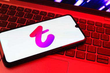 Prag, Çek Cumhuriyeti - 08 01 2025: Dizüstü bilgisayarın üzerinde duran bir cep telefonu Tango logosunu gösteriyor. Tango, görüntülü aramalar, mesajlar ve canlı yayınlar için sosyal bir uygulama..