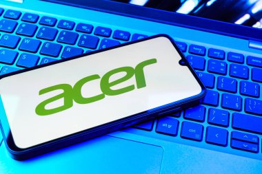 Prag, Çek Cumhuriyeti - 08 01 2025: Dizüstü bilgisayarın üzerinde duran bir cep telefonu Acer logosunu gösterir. Acer bilgisayar ve elektronik üreten bir teknoloji şirketidir..