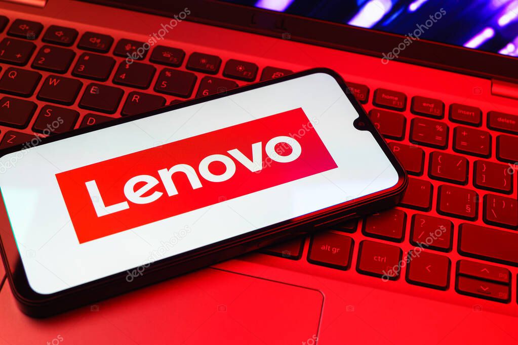 Prague, Czechia - 08 01 2025: A mobile phone lying on a laptop keyboard displays the Lenovo logo. Lenovo is a technology company producing computers and electronics.