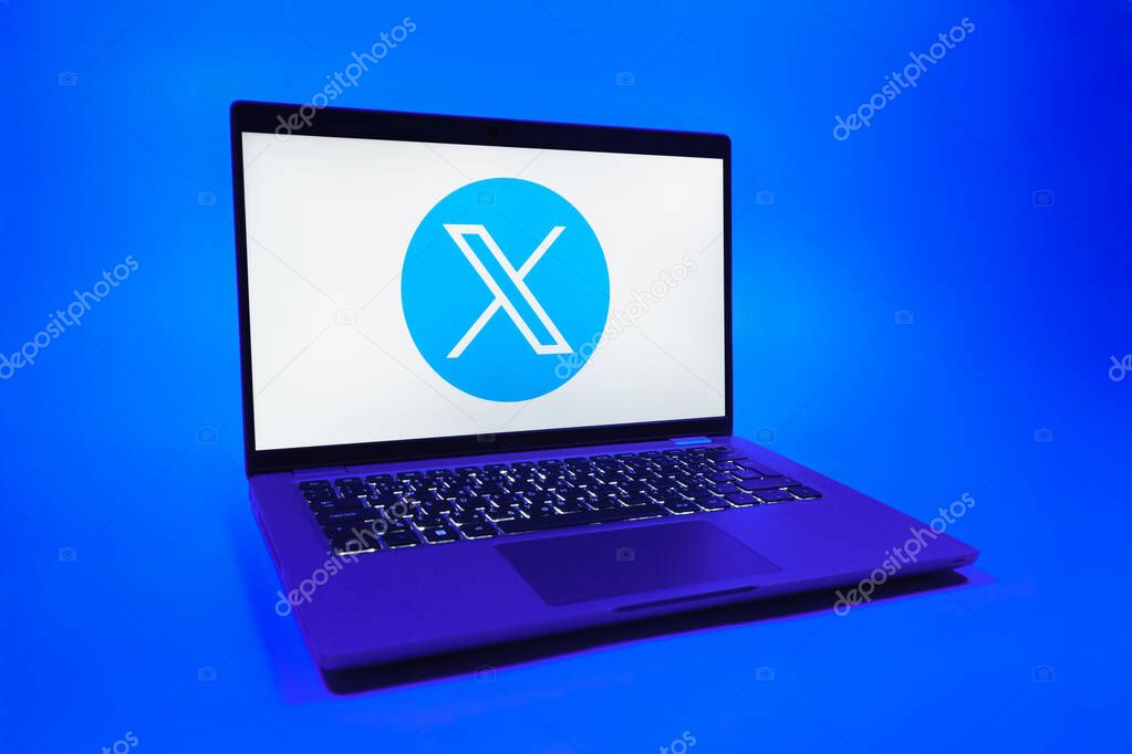 Prague, Czechia - 08 01 2025: A laptop on a uniform background displays the X logo. X is a platform for sharing short posts and updates.