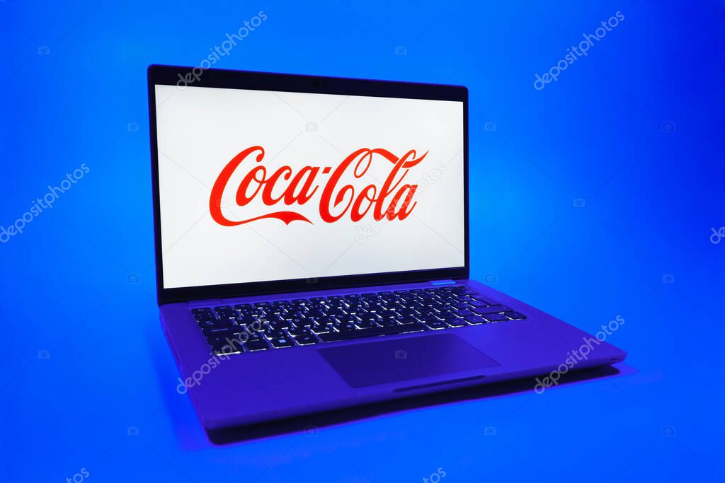 Prague, Czechia - 08 01 2025: A laptop on a uniform background displays the Coca-Cola logo. Coca-Cola is a beverage company known for its soft drinks.