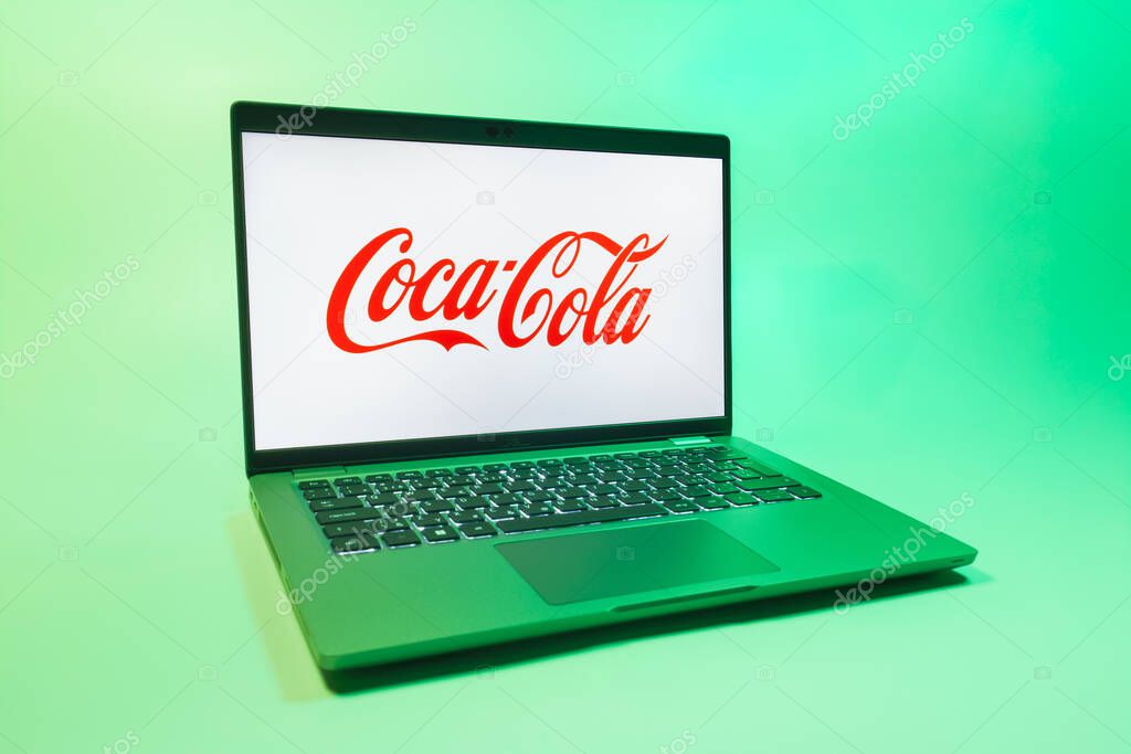 Prague, Czechia - 08 01 2025: A laptop on a uniform background displays the Coca-Cola logo. Coca-Cola is a beverage company known for its soft drinks.