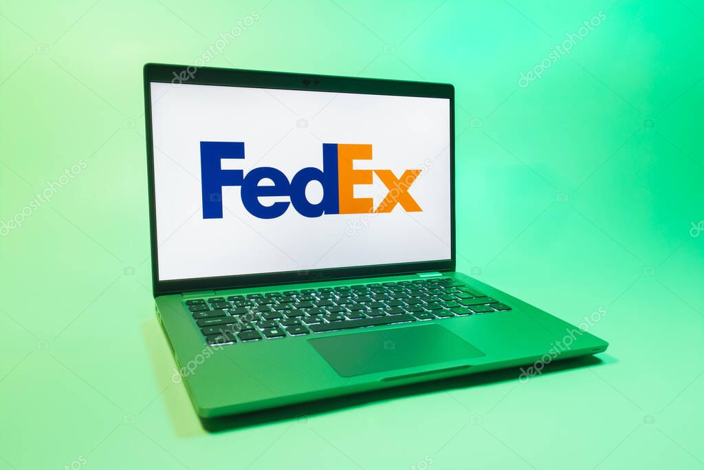 Prague, Czechia - 08 01 2025: A laptop on a uniform background displays the FedEX logo. FedEX is a logistics company providing shipping and courier services.