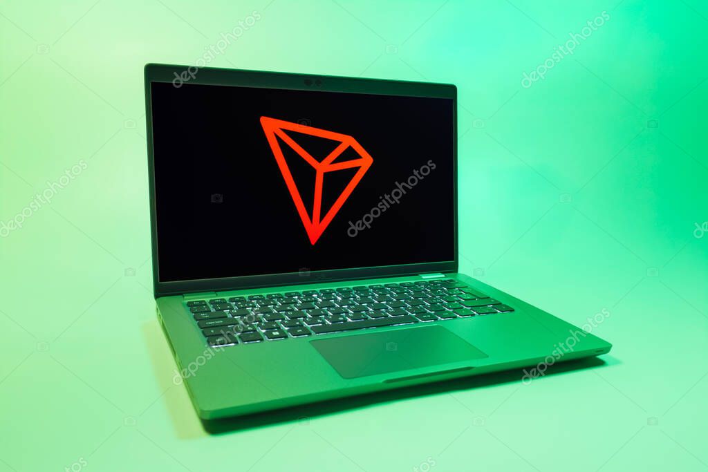 Prague, Czechia - 08 01 2025: A laptop on a uniform background displays the Tron logo. Tron is a blockchain platform for decentralized applications.