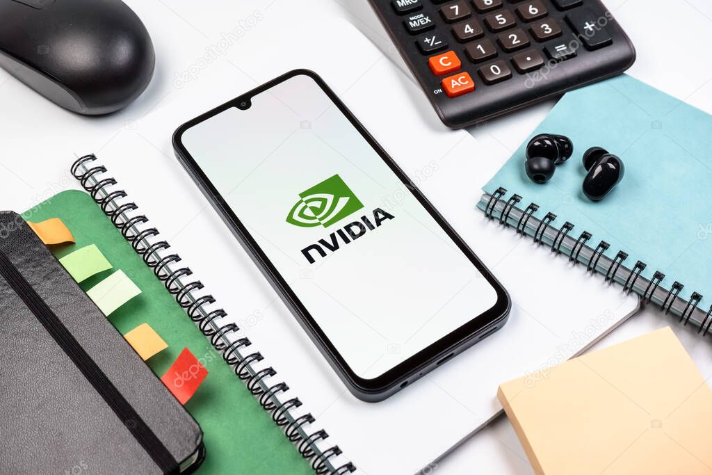 Prague, Czechia - 08 18 2025: An arrangement of office supplies with a mobile phone in the center displaying NVIDIA logo. NVIDIA is a technology company specializing in GPUs and AI hardware.