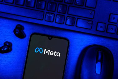 Prague, Czechia - 08 09 2025: A top-down view of a desk with a phone displaying the Meta logo. Meta is a company offering social platforms like Facebook and Instagram.