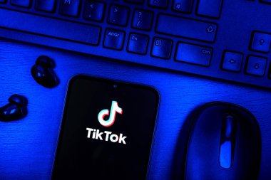 Prague, Czechia - 08 09 2025: A top-down view of a desk with a phone displaying the TikTok logo. TikTok is a platform for short, creative, and viral videos.
