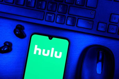 Prague, Czechia - 08 09 2025: A top-down view of a desk with a phone displaying the Hulu logo. Hulu is a streaming platform for TV shows, movies, and live TV.