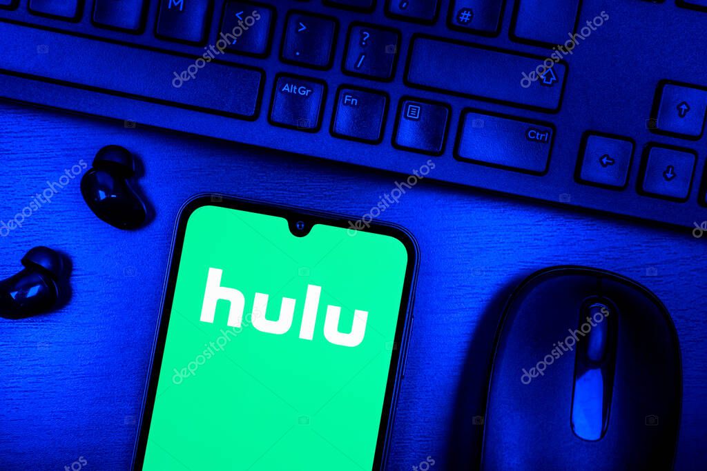Prague, Czechia - 08 09 2025: A top-down view of a desk with a phone displaying the Hulu logo. Hulu is a streaming platform for TV shows, movies, and live TV.