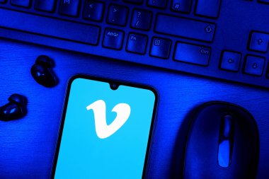 Prague, Czechia - 08 09 2025: A top-down view of a desk with a phone displaying the Vimeo logo. Vimeo is a platform for hosting and sharing high-quality videos.