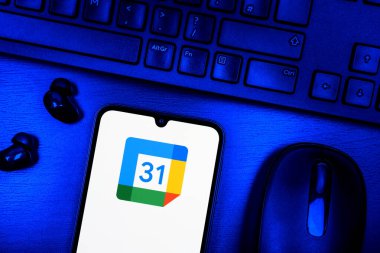Prague, Czechia - 08 09 2025: A top-down view of a desk with a phone displaying the Google Calendar logo. Google Calendar is a platform for scheduling and managing events.