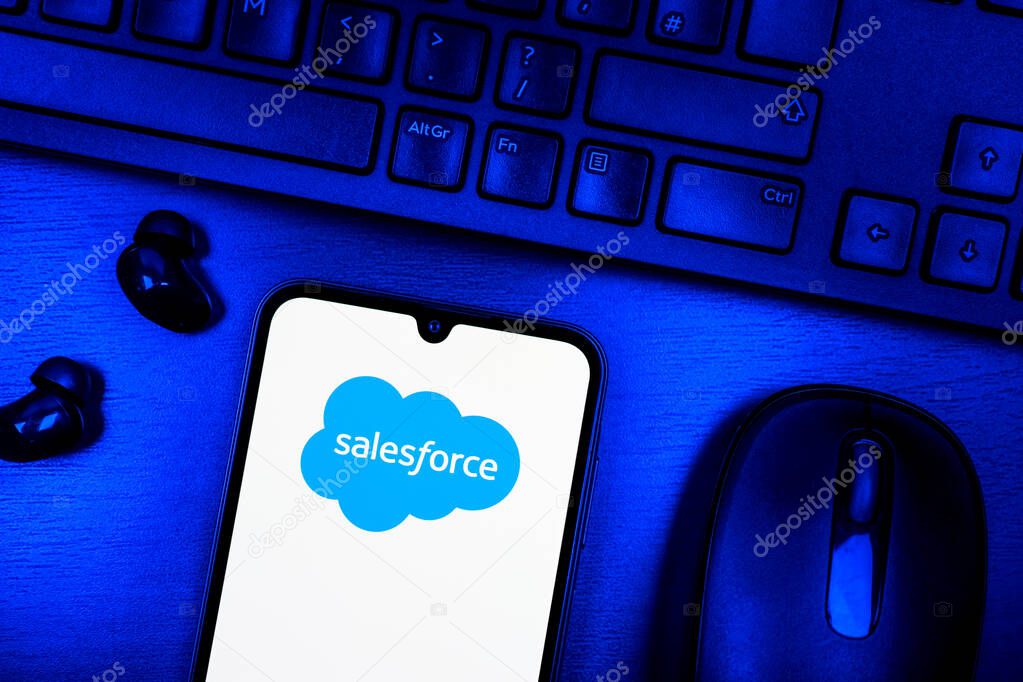 Prague, Czechia - 08 09 2025: A top-down view of a desk with a phone displaying the Salesforce logo. Salesforce is a platform for customer relationship management and cloud services.