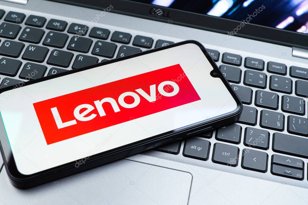 Prague, Czechia - 08 01 2025: A mobile phone lying on a laptop keyboard displays the Lenovo logo. Lenovo is a technology company producing computers and electronics.