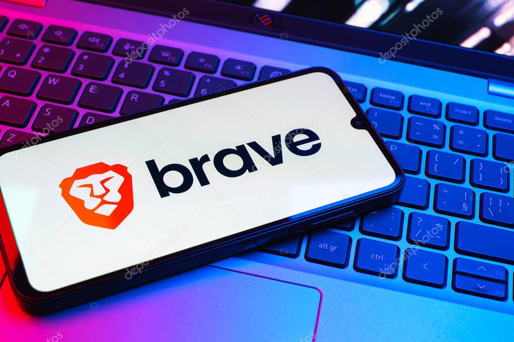 Prague, Czechia - 08 01 2025: A mobile phone lying on a laptop keyboard displays the Brave logo. Brave is a web browser focused on privacy and speed.