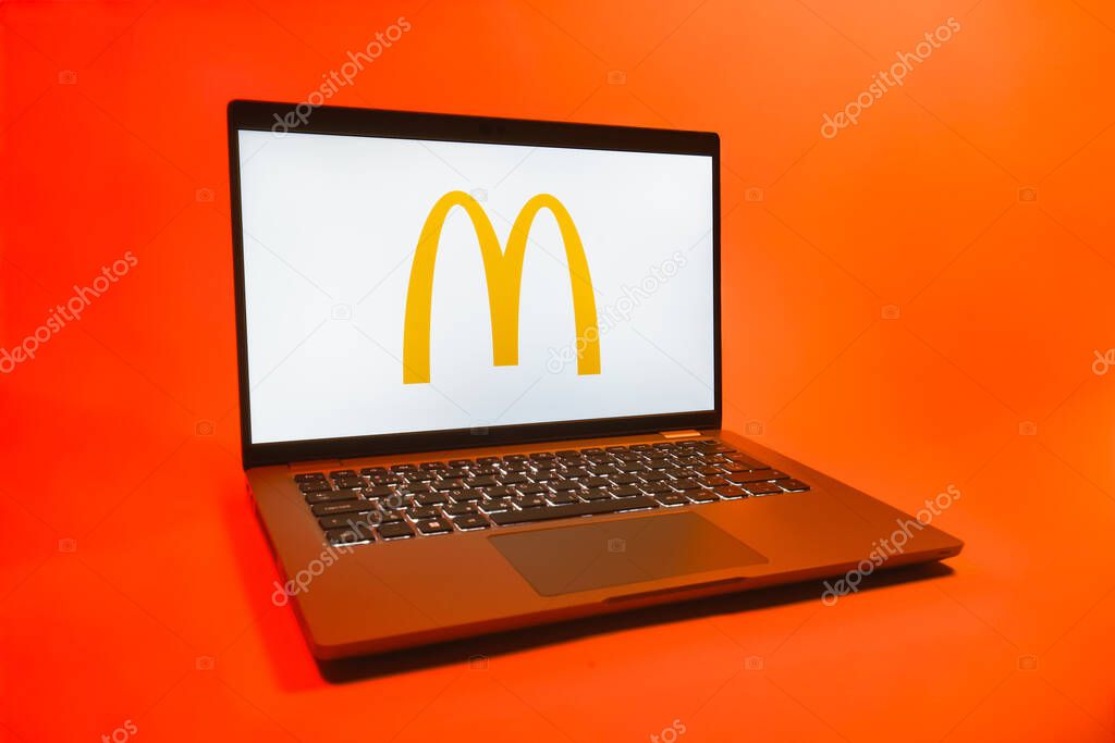 Prague, Czechia - 08 01 2025: A laptop on a uniform background displays the McDonalds logo. McDonalds is a fast-food chain serving burgers, fries, and more.