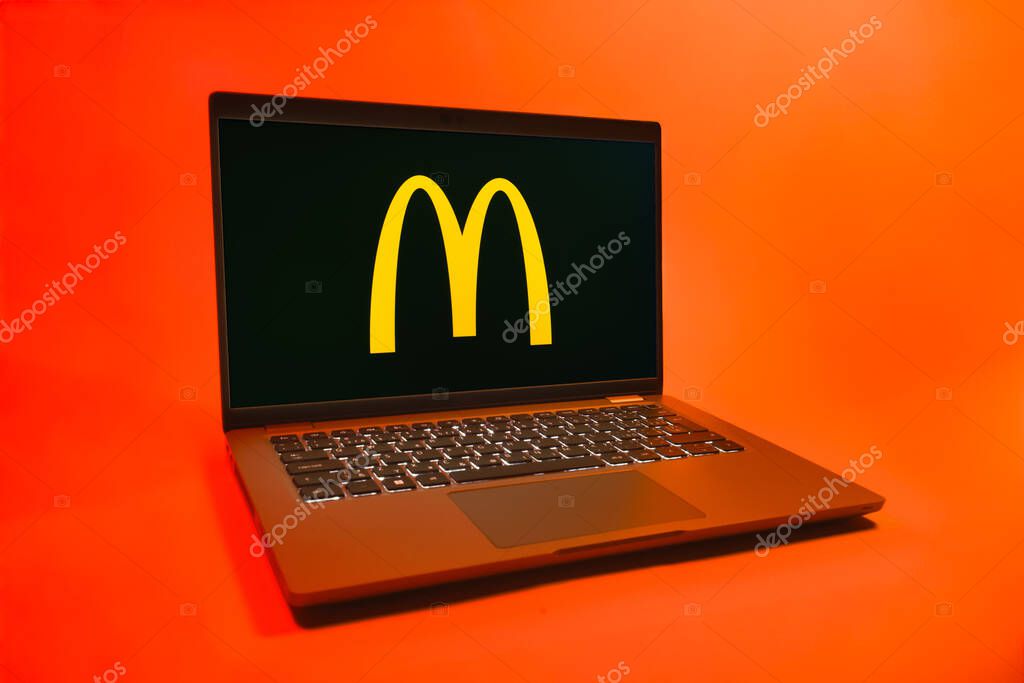 Prague, Czechia - 08 01 2025: A laptop on a uniform background displays the McDonalds logo. McDonalds is a fast-food chain serving burgers, fries, and more.