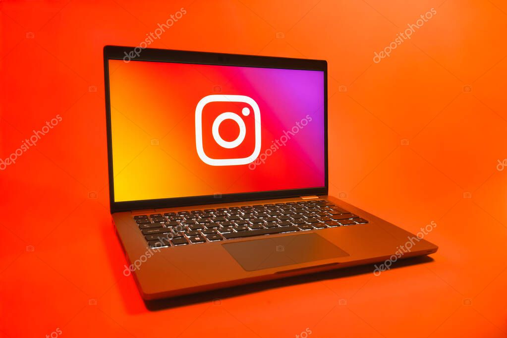 Prague, Czechia - 08 01 2025: A laptop on a uniform background displays the Instagram logo. Instagram is a social media platform for sharing photos and videos.