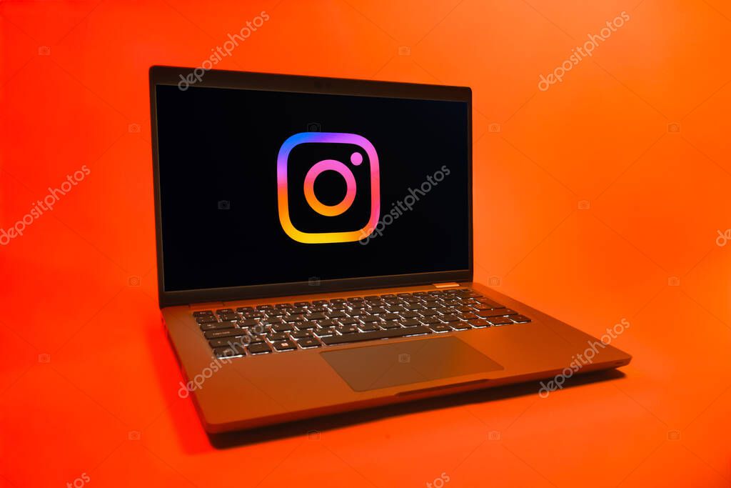 Prague, Czechia - 08 01 2025: A laptop on a uniform background displays the Instagram logo. Instagram is a social media platform for sharing photos and videos.