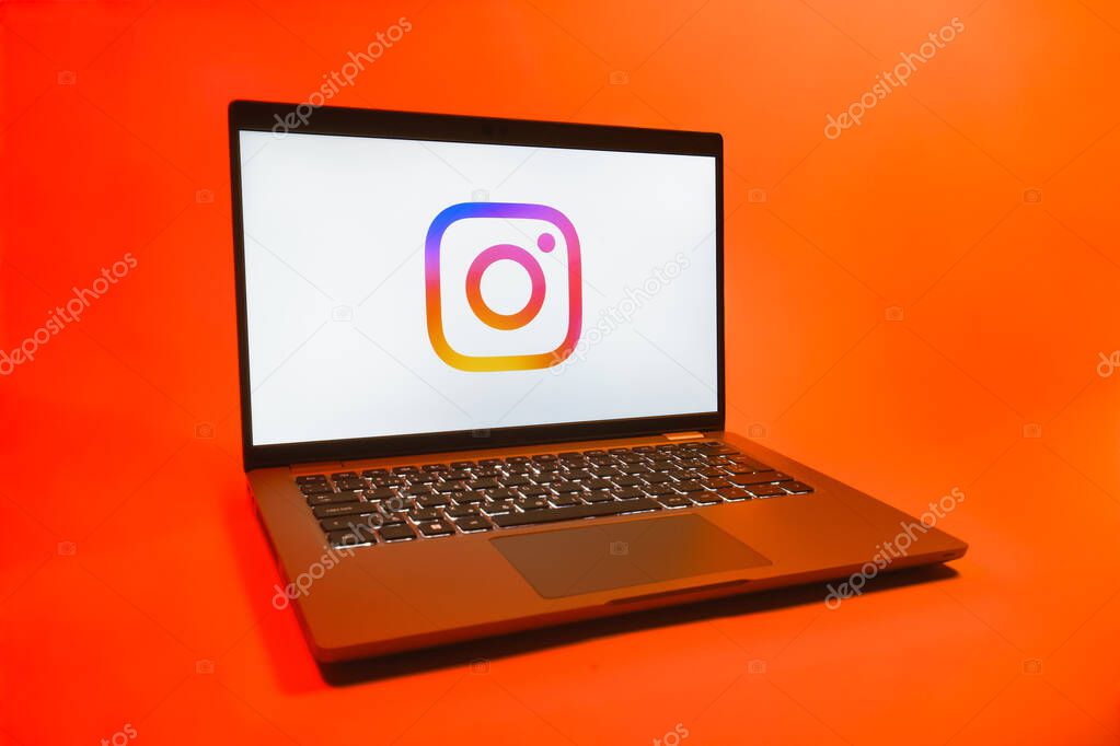 Prague, Czechia - 08 01 2025: A laptop on a uniform background displays the Instagram logo. Instagram is a social media platform for sharing photos and videos.