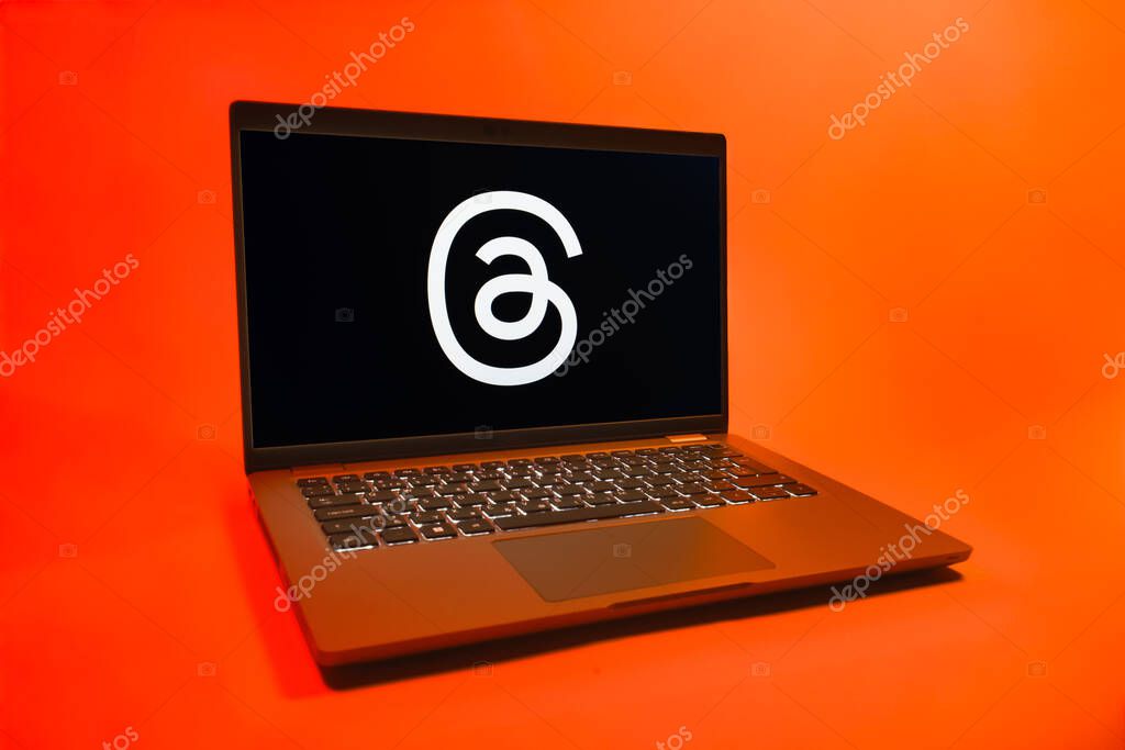 Prague, Czechia - 08 01 2025: A laptop on a uniform background displays the Threads logo. Threads is a social media platform for sharing short posts and updates.