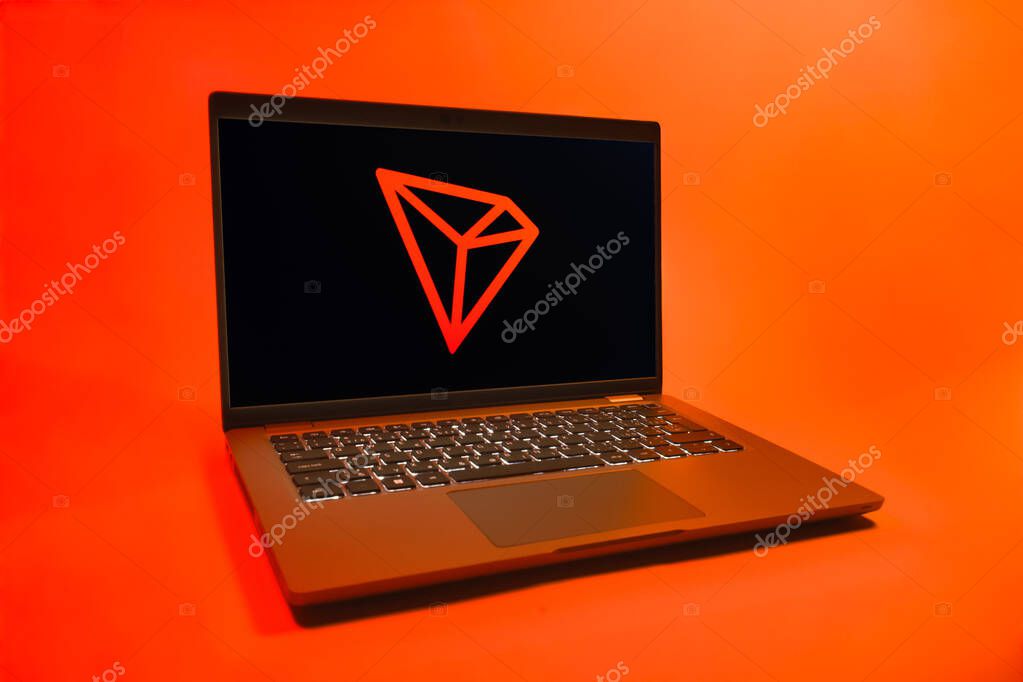 Prague, Czechia - 08 01 2025: A laptop on a uniform background displays the Tron logo. Tron is a blockchain platform for decentralized applications.