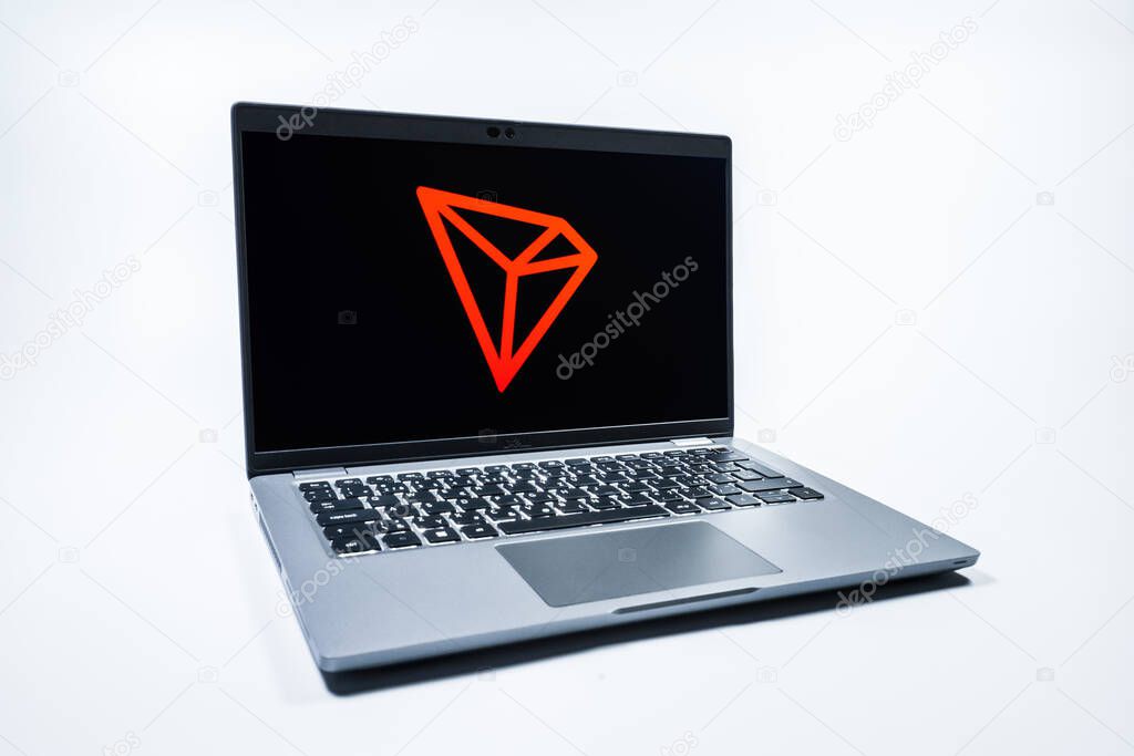 Prague, Czechia - 08 01 2025: A laptop on a uniform background displays the Tron logo. Tron is a blockchain platform for decentralized applications.