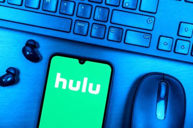 Prague, Czechia - 08 09 2025: A top-down view of a desk with a phone displaying the Hulu logo. Hulu is a streaming platform for TV shows, movies, and live TV.