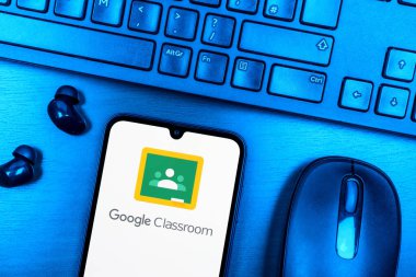 Prague, Czechia - 08 09 2025: A top-down view of a desk with a phone displaying the Google Classroom logo. Google Classroom is a platform for managing classes and educational content.