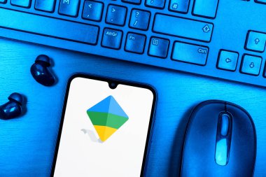 Prague, Czechia - 08 09 2025: A top-down view of a desk with a phone displaying the Google Family Link logo. Google Family Link is a platform for parental control and child account management.