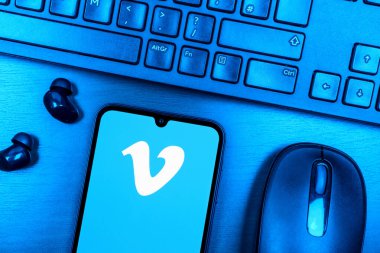 Prague, Czechia - 08 09 2025: A top-down view of a desk with a phone displaying the Vimeo logo. Vimeo is a platform for hosting and sharing high-quality videos.
